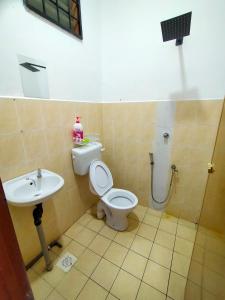 a bathroom with a toilet and a sink at Kak Zai Homestay Port Dickson With Private Pool in Port Dickson