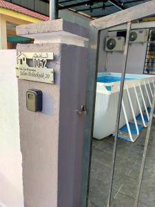 a sign on the side of a building next to a boat at Kak Zai Homestay Port Dickson With Private Pool in Port Dickson