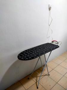 a black iron table with a computer mouse on it at Kak Zai Homestay Port Dickson With Private Pool in Port Dickson