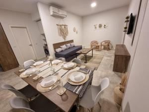 a dining table and chairs in a living room at Boho Homes in Hurghada