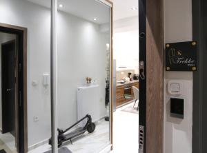 a mirror in a bathroom next to a room at LA Larissa Luxury Apartments Trekke in Larisa