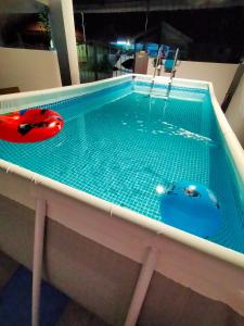 a pool with two inflatable boats in it at Kak Zai Homestay Port Dickson With Private Pool in Port Dickson