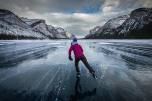 a woman riding skis down a snow covered slope at Banff Park Lodge in Banff