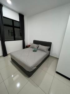 a bedroom with a bed in a room with a window at Desaru Utama Residance Aisy Homestay in Kota Tinggi +31 photos