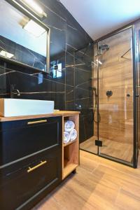 a bathroom with a sink and a shower at Selfie's Boutique Hotel in Tiberias