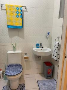 a small bathroom with a toilet and a sink at SUCCESS ROOM Ensuit - East Legon, Adjiringanor in Accra