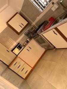 an overhead view of a kitchen with white cabinets at SUCCESS ROOM Ensuit - East Legon, Adjiringanor in Accra