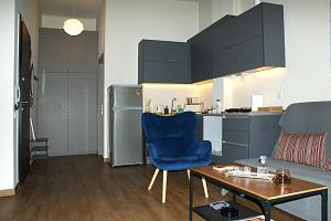salon z niebieskim krzesłem i stołem w obiekcie Central studio in Monastiraki w Atenach +11 zdjęć