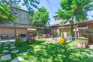 a backyard with a playground in the yard at Koisha in Bishkek