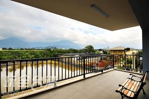 a balcony with a view of a river and mountains at CoCo Motel Boutique in Puli