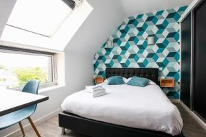 A bed or beds in a room at Contact Hôtel de Matignon