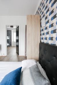 A bed or beds in a room at Contact Hôtel de Matignon