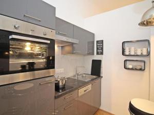 a kitchen with a sink and stainless steel appliances at Ferienwohnung Kings in Vienna