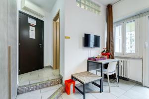 a room with a table and a television and a door at B&B Casa Der Poeta in Rome