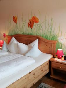 a bedroom with a bed with flowers on the wall at Ferienhof Moyer in Höslwang