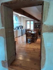 a kitchen and dining room with a table and chairs at Gite le grenier des maraichers in Albigny-sur-Saone