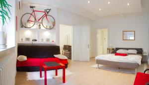 a bedroom with a bed and a bike on the wall at Apartment Red Bike in Zagreb