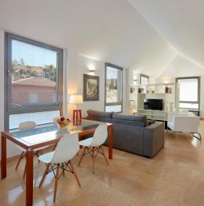 a living room with a couch and a table and chairs at Loft Homelike in Granada