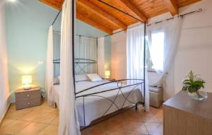 a bedroom with a canopy bed and a window at Villa Nunziatella Badia in Trappeto +139 photos