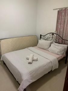 a bed with a teddy bear sitting on it at 3 bedroom Paul Meranti A303 Genting Highland Vacation Home in Genting Highlands