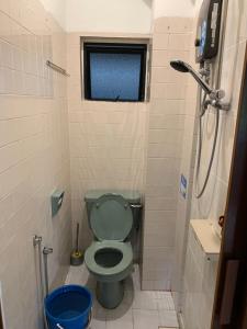 a bathroom with a green toilet and a shower at 3 bedroom Paul Meranti A303 Genting Highland Vacation Home in Genting Highlands