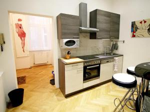 a kitchen with a sink and a stove top oven at Ferienwohnung Urban-Loritz in Vienna