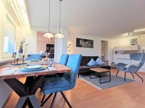 a dining room and living room with a table and chairs at Designapartment Vitibuck in Waldshut-Tiengen