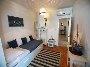a small bedroom with a bed and a table at Villa Ana in Rab