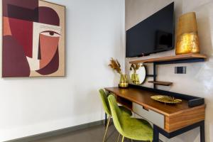 a dining room with a desk and a tv at Hotel Vespucci in Porto Cesareo