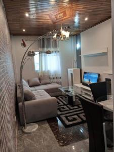 ein Wohnzimmer mit einem Sofa und einem Tisch in der Unterkunft Studio meublé haut standing jouvence Yaoundé in Jaunde