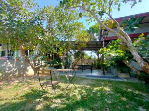 a table and chairs under a tree in a yard at DOX Ko Lanta in Ko Lanta