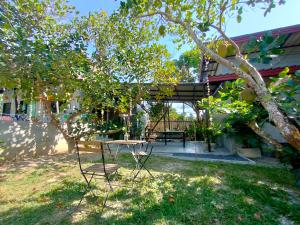 a table and chairs under a tree in a yard at DOX Ko Lanta in Ko Lanta