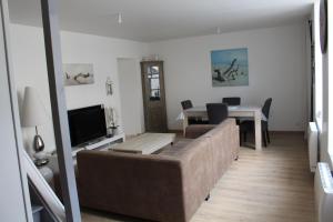 a living room with a couch and a table at Comme chez soi in Givet