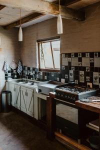 a kitchen with a stove and a sink at African Leaves Trout Lodge in Dullstroom +81 photos