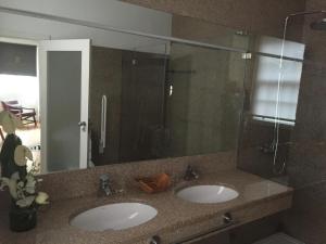 a bathroom with two sinks and a large mirror at Solar Do Castelo in Melgaço