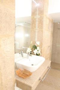 a bathroom with a sink and a mirror at Solar Do Castelo in Melgaço