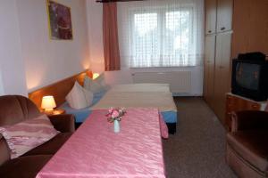 a hotel room with two beds and a tv at Ferienwohnung Tor zur Ostsee - a55965 in Mellenthin