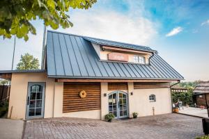 a building with a black roof at HANDMADE LATGOLA - vairāk kā vienkārši "naktsmītne" in Līvāni