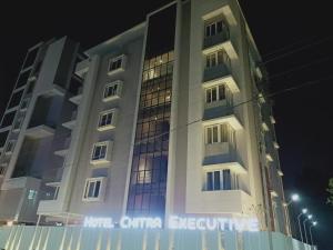 a building with a sign on the side of it at Hotel Chitra Executive in Solapur