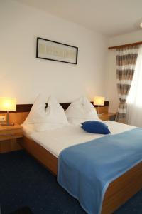 a bedroom with a large bed with a blue blanket at Sonnenhügel in Ramsau am Dachstein