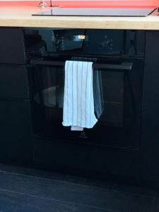 a microwave oven with two towels hanging from it at Green peaceful ultra central apartment, 2 bedrooms, Streaming, Workspaces in Cluj-Napoca