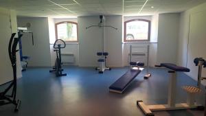 a gym with treadmills and machines in a room at T2 + Tout Confort + Terrasse in Aulus-les-Bains