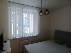 Posteľ alebo postele v izbe v ubytovaní Apartament Artemida