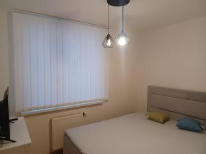 Posteľ alebo postele v izbe v ubytovaní Apartament Artemida