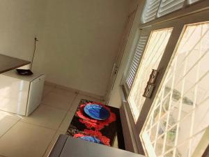a small kitchen with a refrigerator and a door at Isa Natal 2 - Banheiro Privativo in Natal