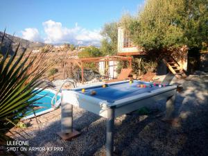 a pool table with balls on it in a yard at Treehouse ,Casa Arbol, with Spa in Algarrobo
