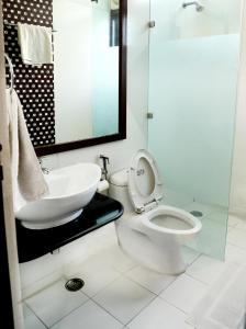 a white bathroom with a toilet and a sink at Indee home in New Delhi