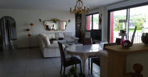 a living room with a couch and a table at Appartement 4 chambres Sur la Cave in Givet