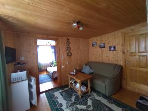 a living room with a couch and a table at Guesthouse U dida Viktora in Yaremche