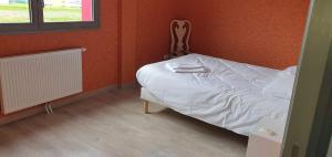 a small bedroom with a bed and a window at Appartement 4 chambres Sur la Cave in Givet